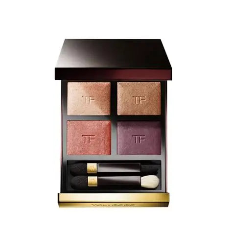 Makeup palette with four shades and two applicators on a white background