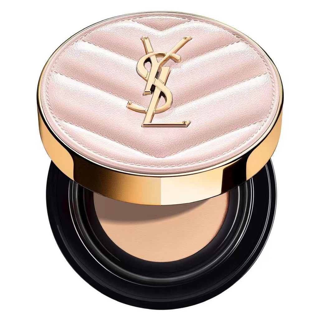 YSL pink cushion foundation compact with gold case on a soft beige background.